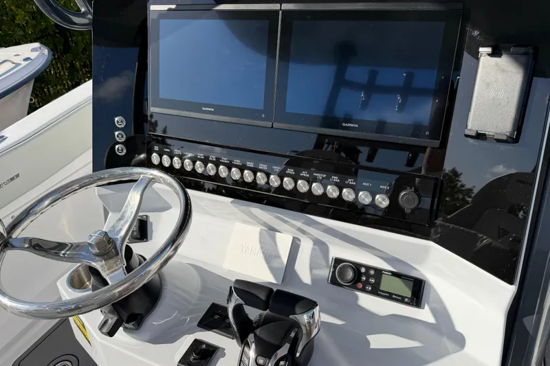  Yacht Photos Pics 2026 Twin Vee 280 GFX2 CC boat dashboard with dual Garmin screens and steering wheel.