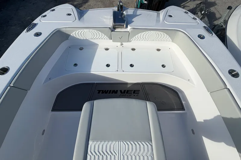  Yacht Photos Pics 2026 Twin Vee 280 GFX2 CC boat interior, featuring sleek seating and storage compartments.