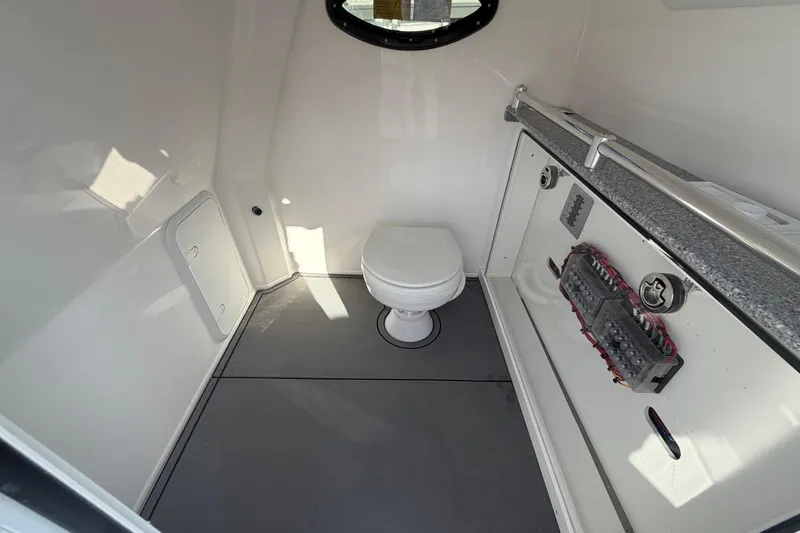  Yacht Photos Pics Interior of 2026 Twin Vee 280 GFX2 CC boat, featuring a compact marine toilet.