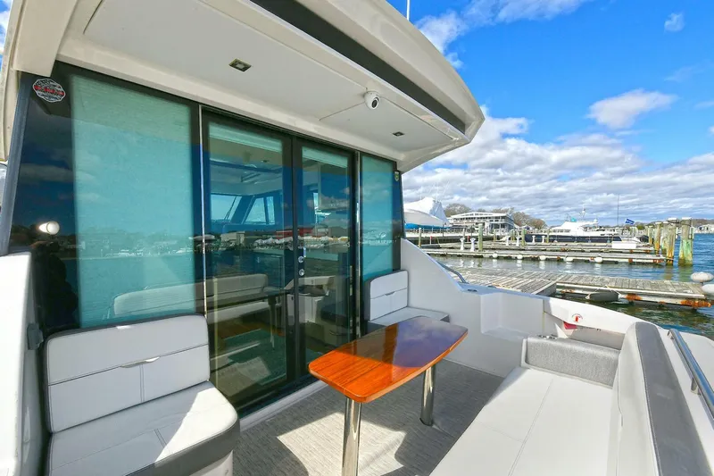 Double Diamond Yacht Photos Pics 2018 Tiara Yachts 39 Coupe with outdoor seating and table, docked at marina.