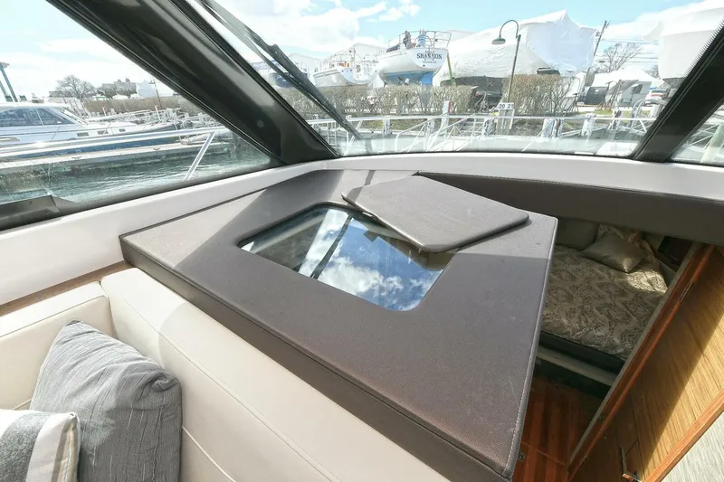 Double Diamond Yacht Photos Pics Interior view of 2018 Tiara Yachts 39 Coupe, featuring a skylight and luxurious seating.