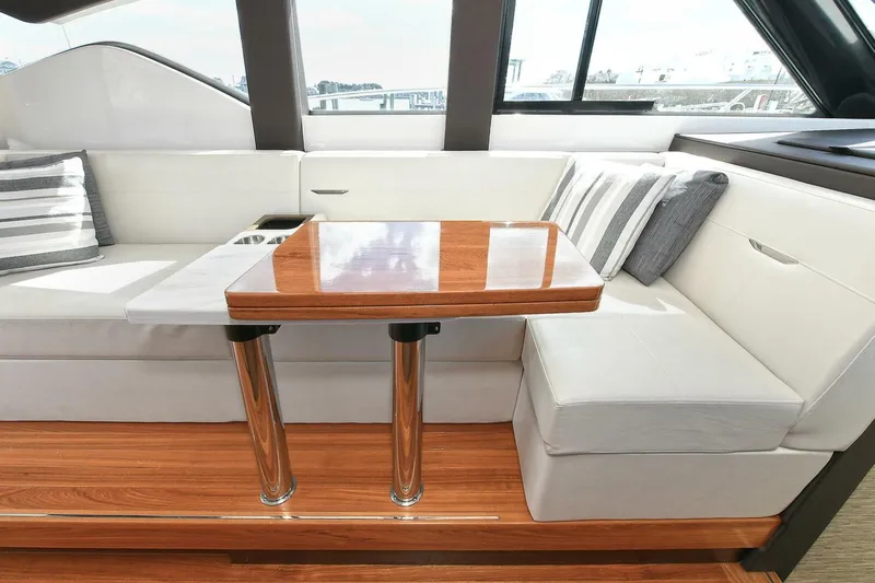 Double Diamond Yacht Photos Pics Luxurious interior of 2018 Tiara Yachts 39 Coupe with elegant seating and wooden table.