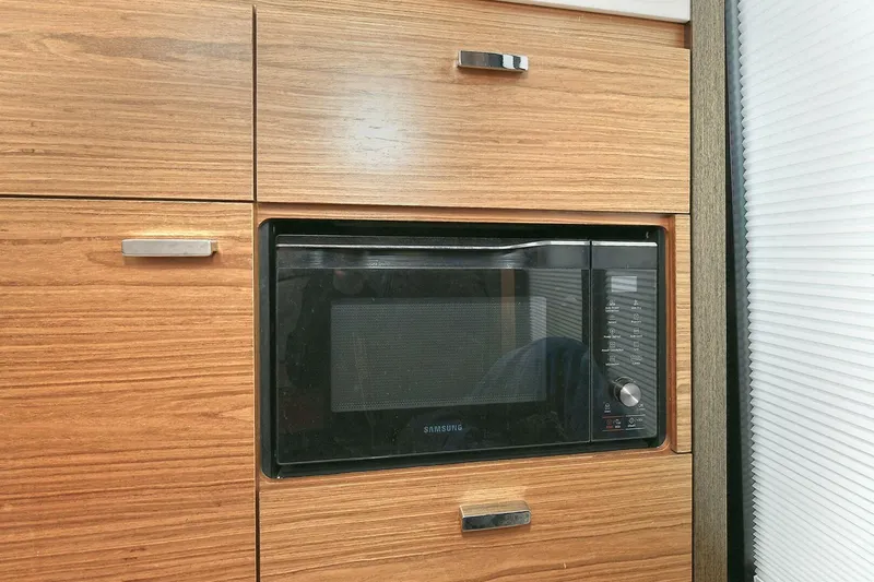 Double Diamond Yacht Photos Pics Built-in microwave in Tiara Yachts 39 Coupe 2018, surrounded by wooden cabinetry.