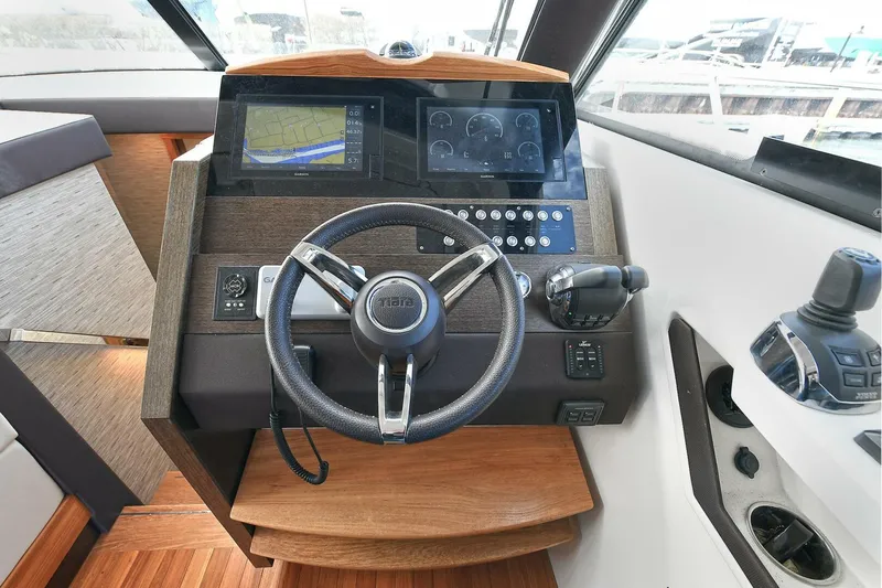 Double Diamond Yacht Photos Pics Helm of 2018 Tiara Yachts 39 Coupe with modern navigation controls and steering wheel.