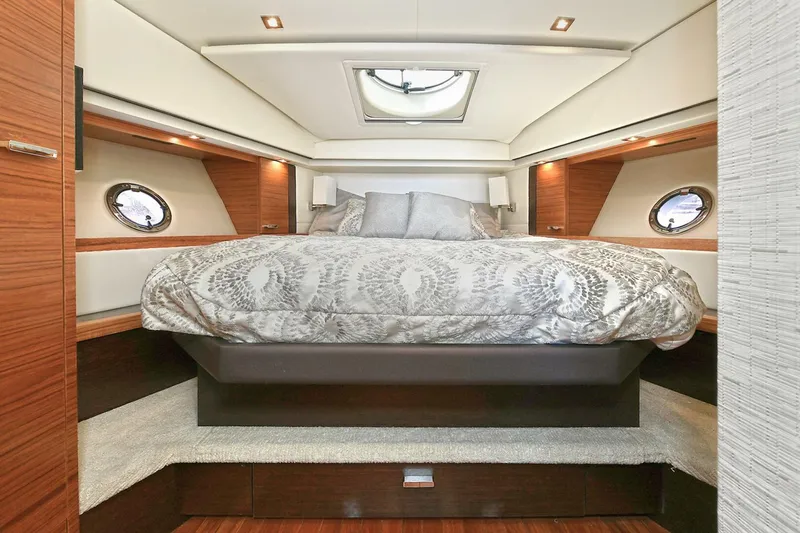 Double Diamond Yacht Photos Pics Luxurious bedroom interior of 2018 Tiara Yachts 39 Coupe with elegant bedding and porthole windows.