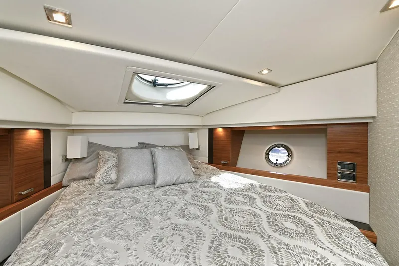 Double Diamond Yacht Photos Pics Luxurious bedroom interior of 2018 Tiara Yachts 39 Coupe with elegant bedding and porthole window.