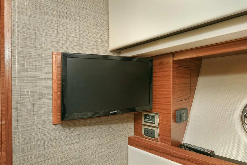 Double Diamond Yacht Photos Pics Interior of 2018 Tiara Yachts 39 Coupe featuring a mounted TV and control panel.