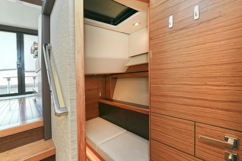 Double Diamond Yacht Photos Pics 2018 Tiara Yachts 39 Coupe interior cabin with wooden finishes and seating area.