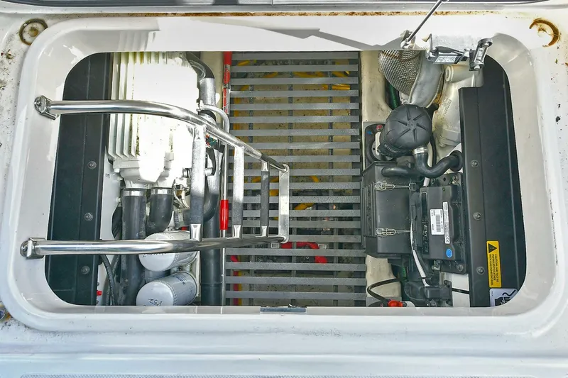 Double Diamond Yacht Photos Pics Engine compartment of 2018 Tiara Yachts 39 Coupe, showcasing mechanical components and ladder.