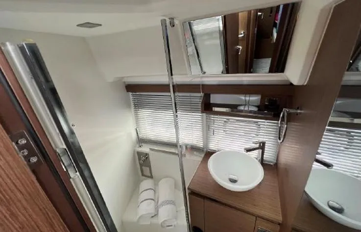  Yacht Photos Pics Modern bathroom in 2020 Jeanneau NC 37 yacht with sleek fixtures and wooden accents.