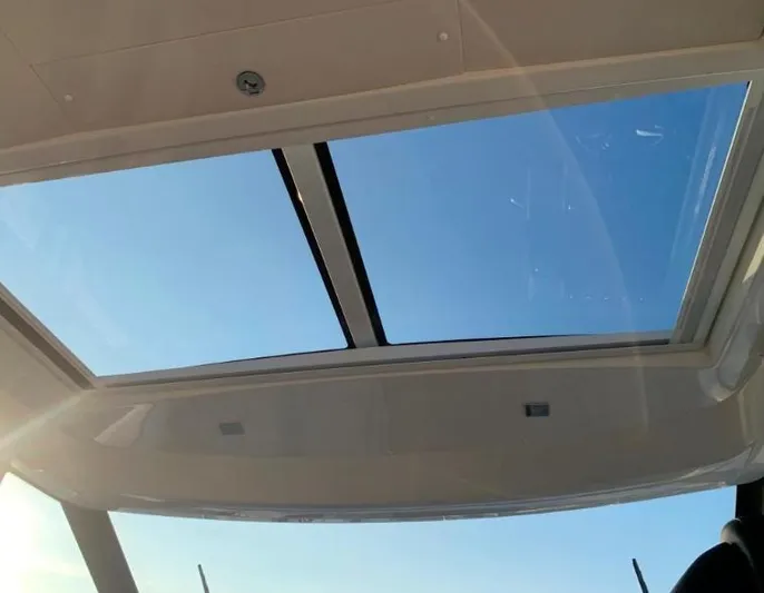  Yacht Photos Pics Sunroof view from 2020 Jeanneau NC 37 boat, showcasing clear blue sky.