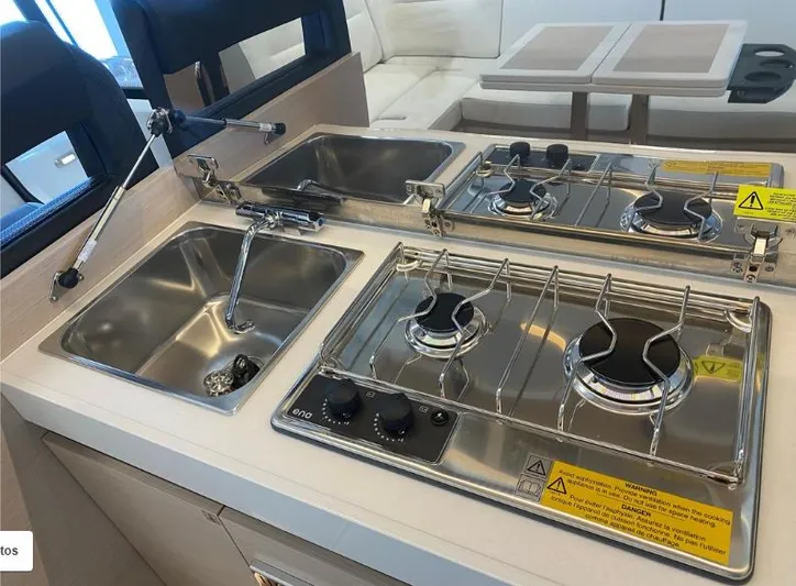  Yacht Photos Pics Compact kitchen area in a 2020 Jeanneau NC 37 boat with stove and sink.