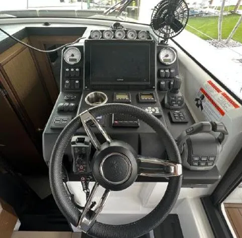  Yacht Photos Pics Cockpit of 2020 Jeanneau NC 37 boat with steering wheel and control panel.