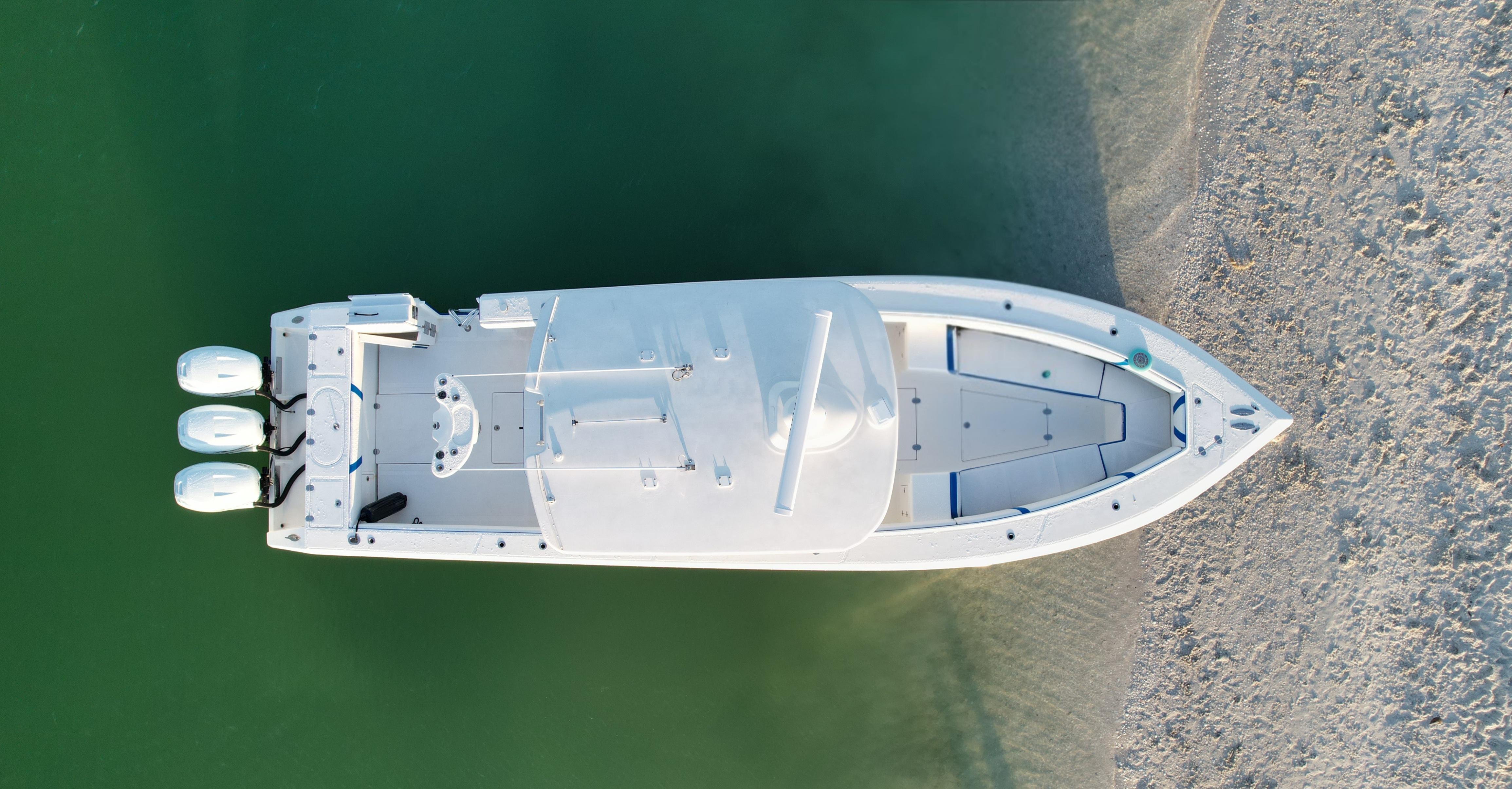 Aerial view of 2016 Venture 39 Forward Seating boat on calm water.