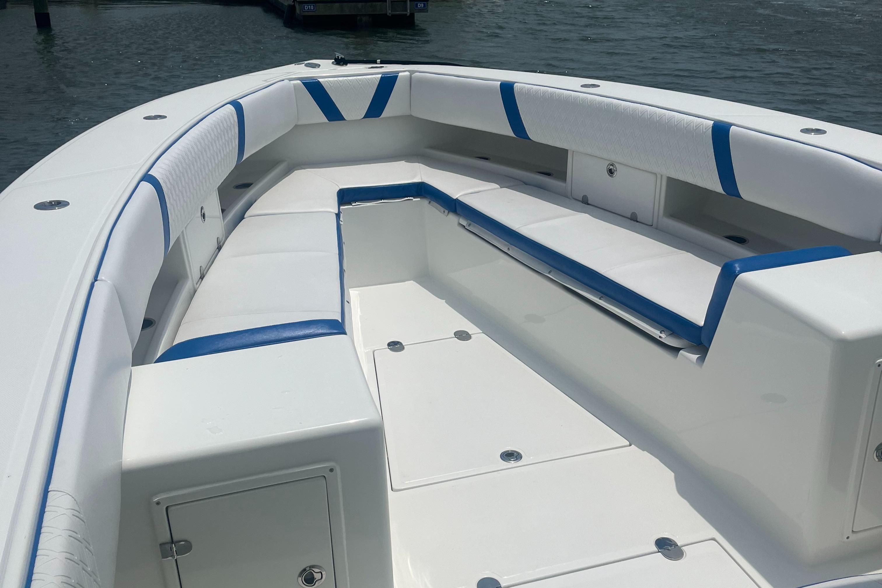 2016 Venture 39 Forward Seating boat with white and blue cushioned seats.