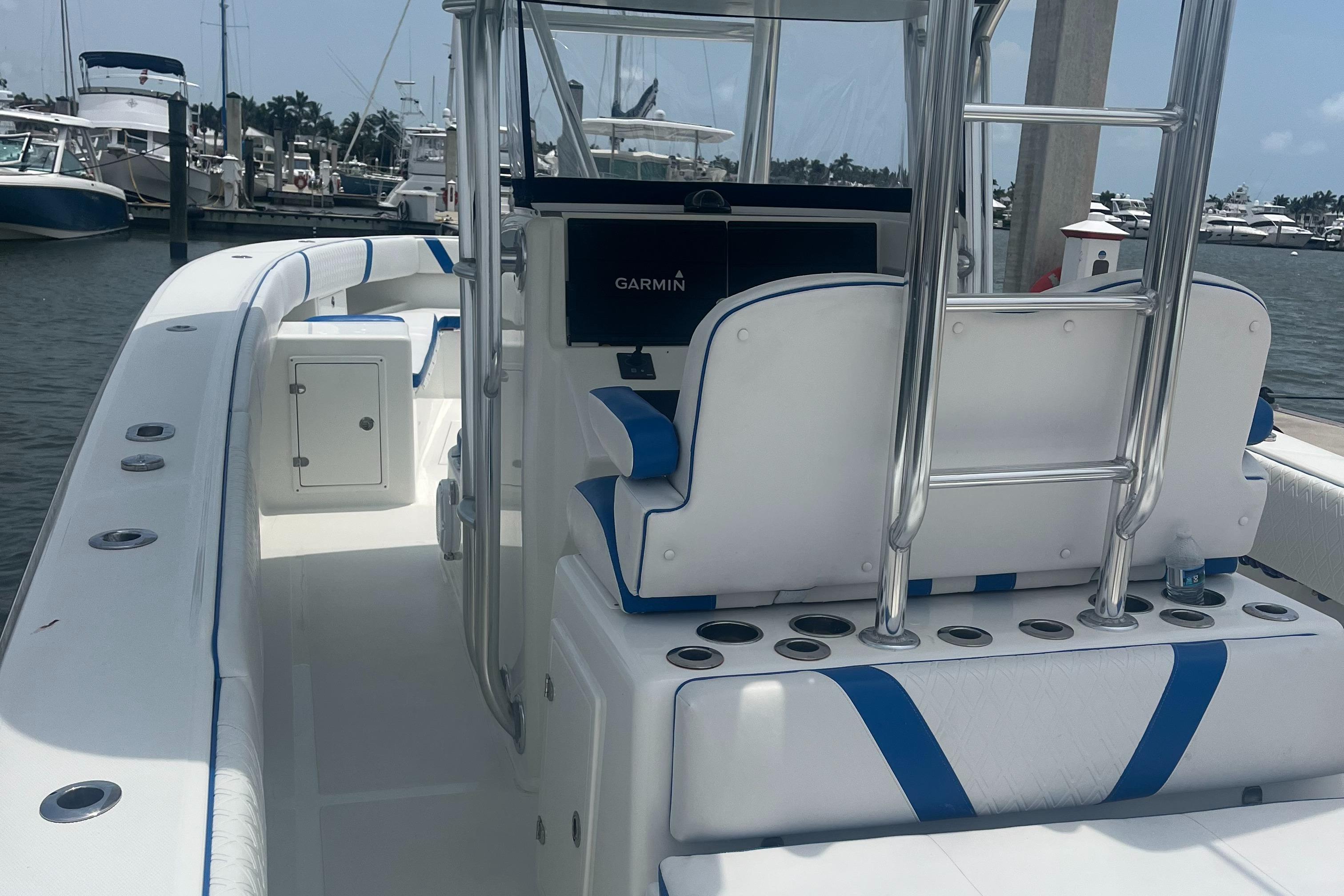 2016 Venture 39 Forward Seating boat with blue and white interior, docked at a marina.
