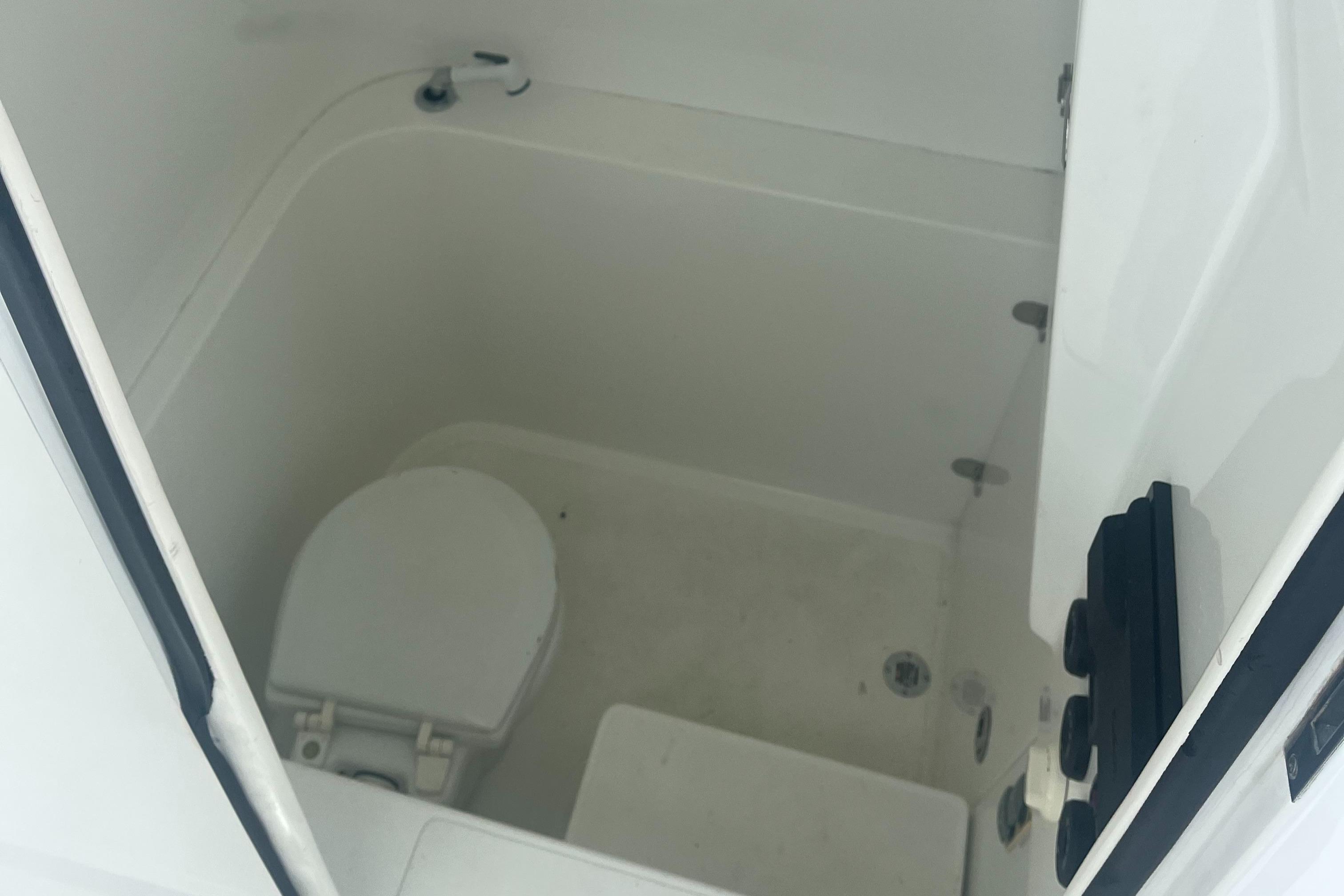 2016 Venture 39 Forward Seating boat interior with compact marine toilet.
