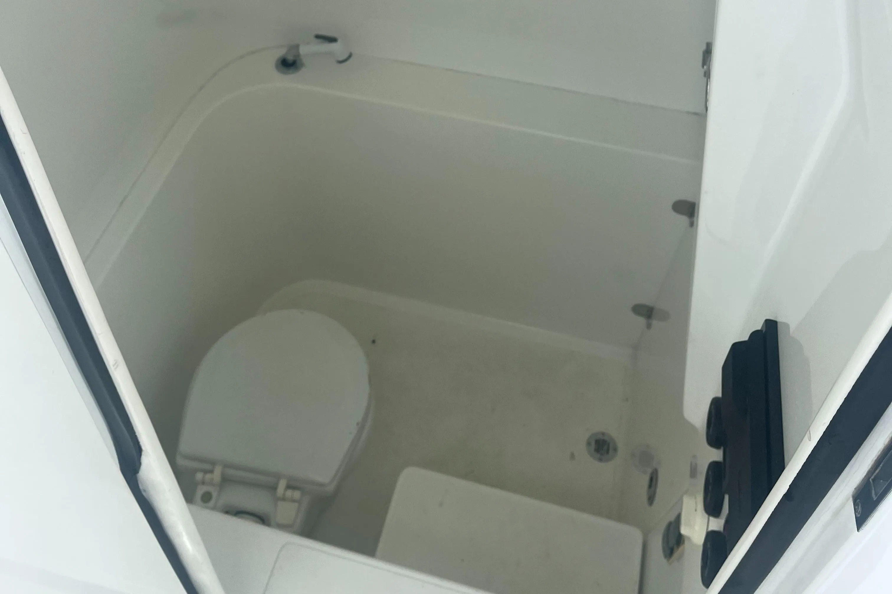 2016 Venture 39 Forward Seating boat interior with compact marine toilet.