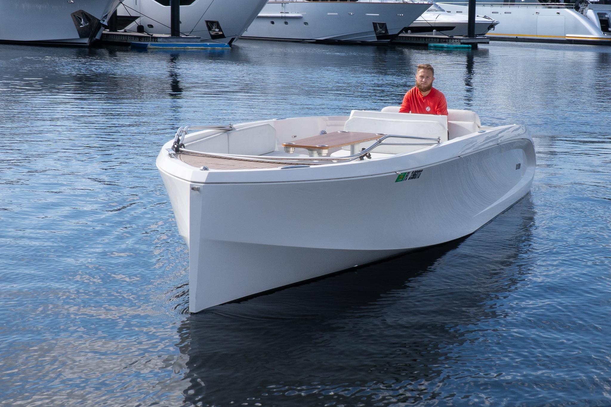 2022 Rand 23 Mana boat on calm water, featuring sleek design and modern aesthetics.