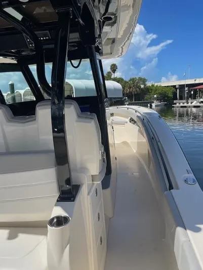Ten Cent Yacht Photos Pics 2022 Scout 355 LXF CC boat interior with sleek seating and modern design.