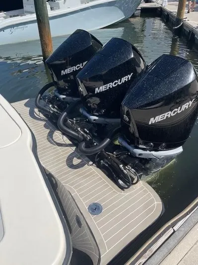 Ten Cent Yacht Photos Pics 2022 Scout 355 LXF CC with triple Mercury outboard engines at dock.