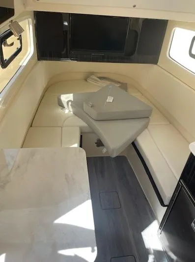 Ten Cent Yacht Photos Pics Interior of 2022 Scout 355 LXF CC boat, featuring seating and table.