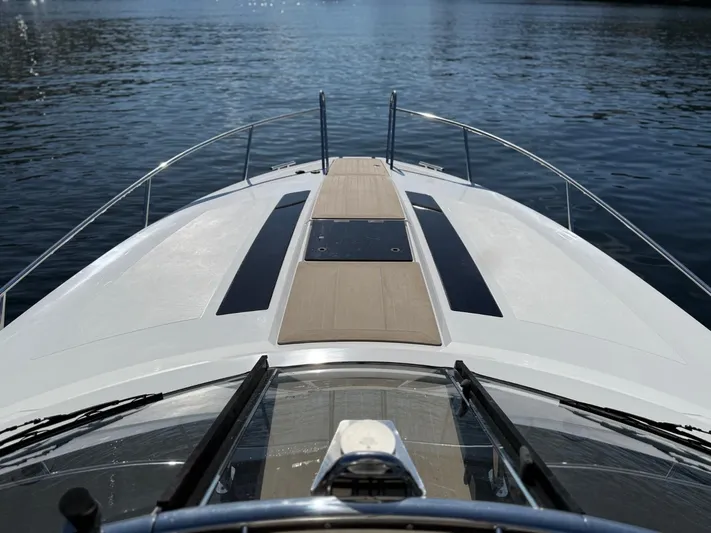  Yacht Photos Pics 2023 Windy 37 Shamal yacht bow on calm water, showcasing sleek design and luxury features.