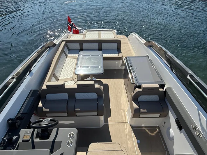  Yacht Photos Pics 2023 Windy 37 Shamal luxury boat interior with seating and table, Norwegian flag visible.