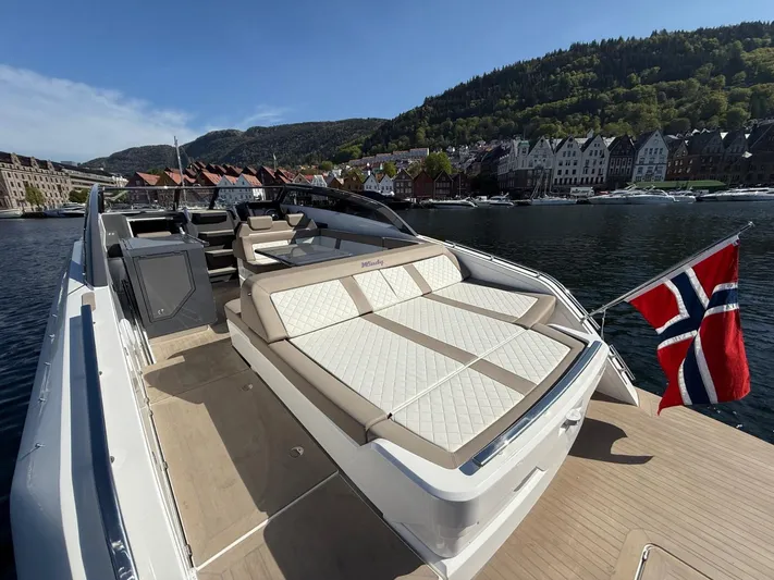  Yacht Photos Pics Luxurious 2023 Windy 37 Shamal yacht with Norwegian flag, docked by scenic waterfront.