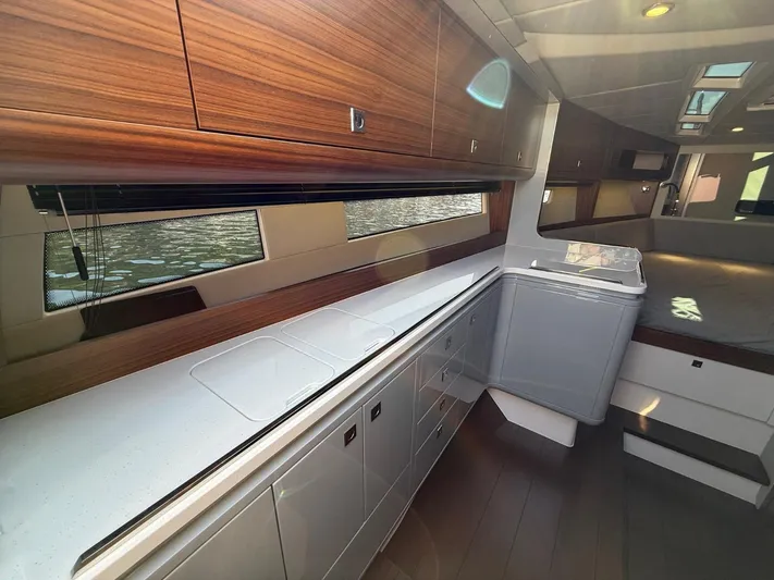  Yacht Photos Pics Interior of 2023 Windy 37 Shamal yacht with sleek kitchen design and wooden cabinetry.
