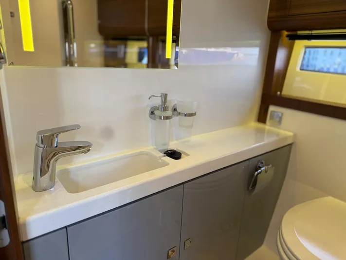  Yacht Photos Pics Modern bathroom interior on 2023 Windy 37 Shamal yacht, featuring sleek sink and fixtures.
