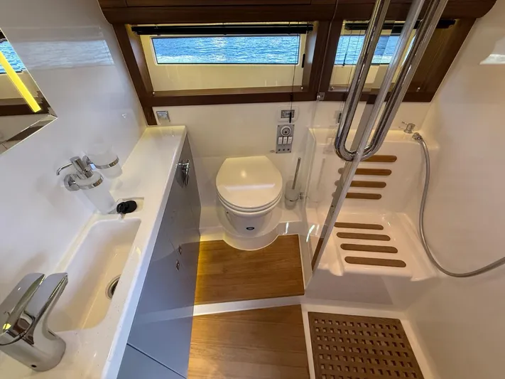  Yacht Photos Pics Modern bathroom in 2023 Windy 37 Shamal yacht with shower, toilet, and sink.