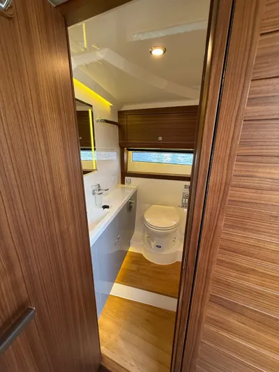  Yacht Photos Pics 2023 Windy 37 Shamal yacht bathroom with wood accents and modern fixtures.