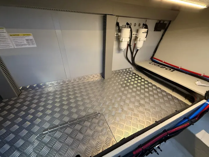  Yacht Photos Pics 2023 Windy 37 Shamal engine compartment with metallic flooring and fuel filters.