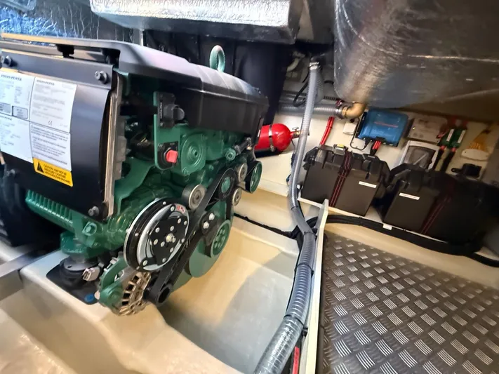  Yacht Photos Pics Engine room of 2023 Windy 37 Shamal, featuring a green engine and various components.