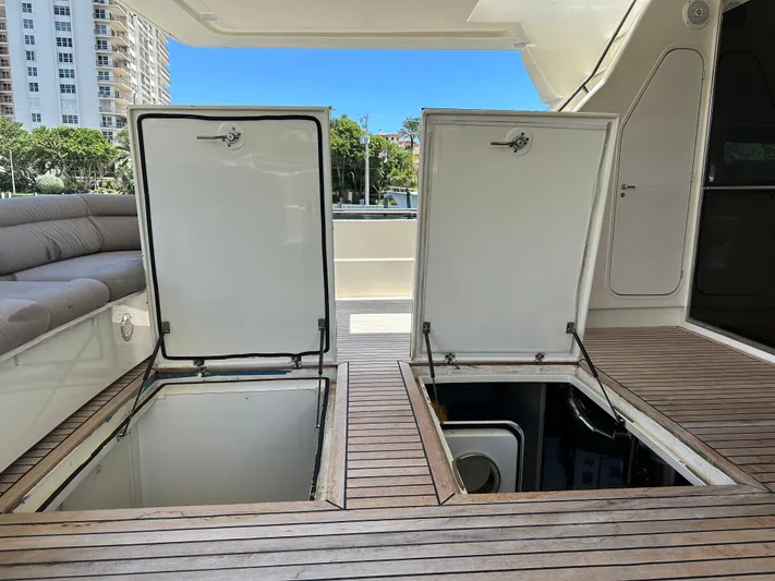  Yacht Photos Pics Open storage compartments on 1998 Ferretti Yachts 80 deck with wooden flooring.