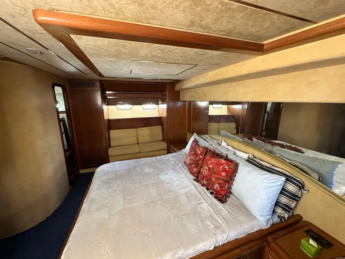  Yacht Photos Pics Luxurious bedroom interior of a 1998 Ferretti Yachts 80, featuring elegant wood finishes.