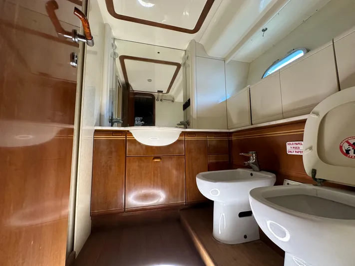  Yacht Photos Pics Luxurious bathroom in 1998 Ferretti Yachts 80, featuring wood accents and modern fixtures.