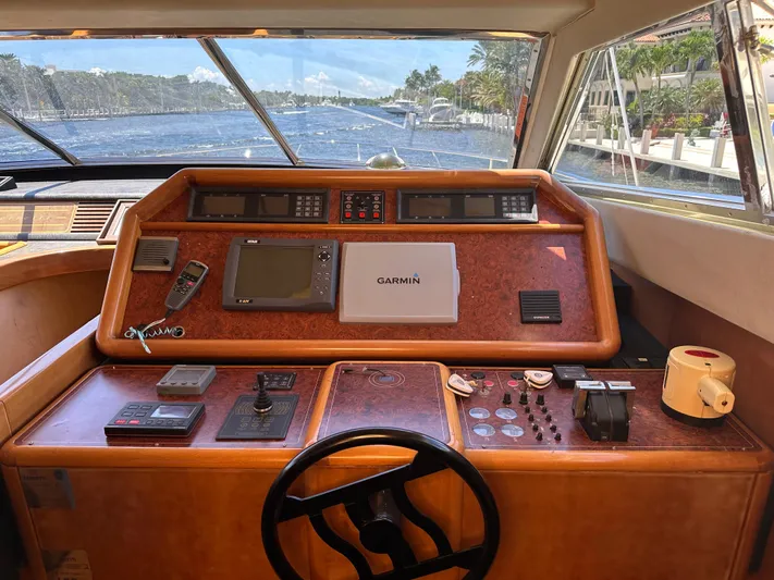  Yacht Photos Pics Helm of 1998 Ferretti Yachts 80 with navigation equipment and scenic waterway view.