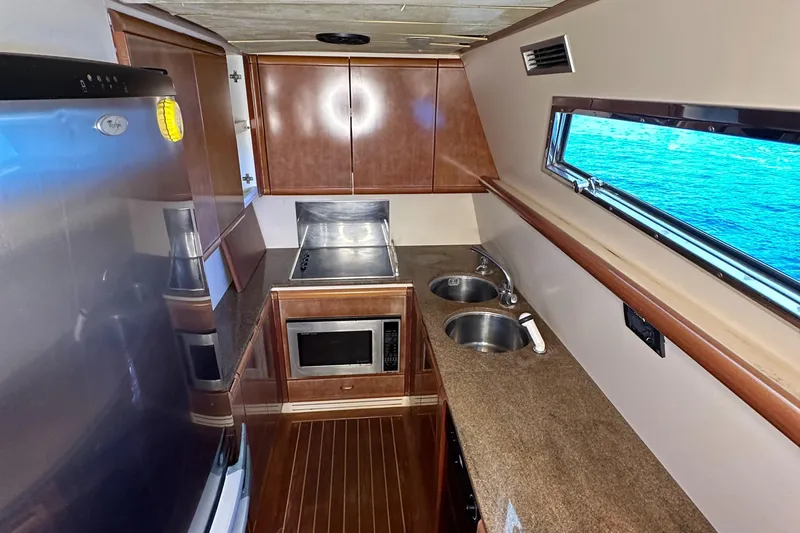  Yacht Photos Pics Galley kitchen in 1998 Ferretti Yachts 80 with ocean view, featuring modern appliances.