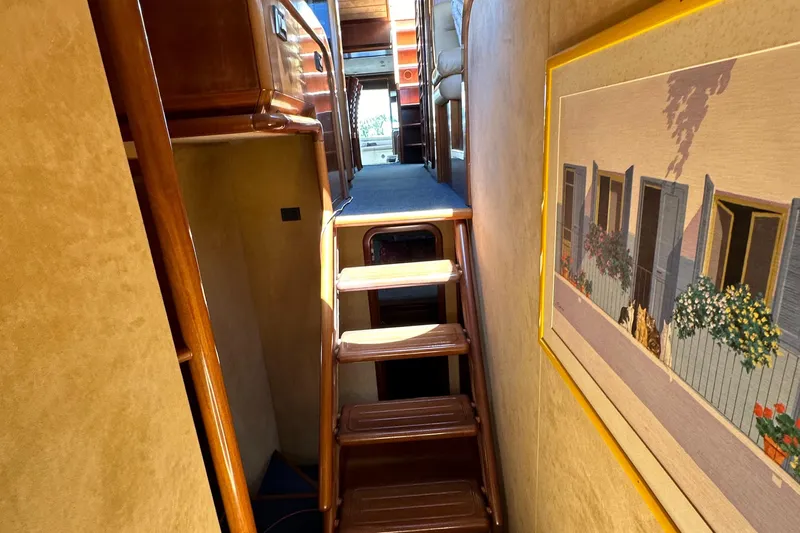  Yacht Photos Pics Interior of 1998 Ferretti Yachts 80 with wooden stairs and wall art.