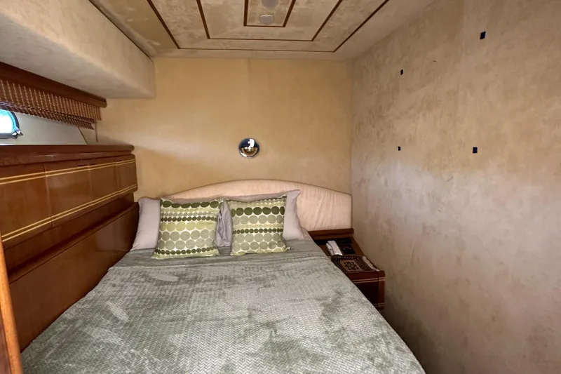  Yacht Photos Pics Cozy bedroom in 1998 Ferretti Yachts 80 with elegant decor and plush bedding.