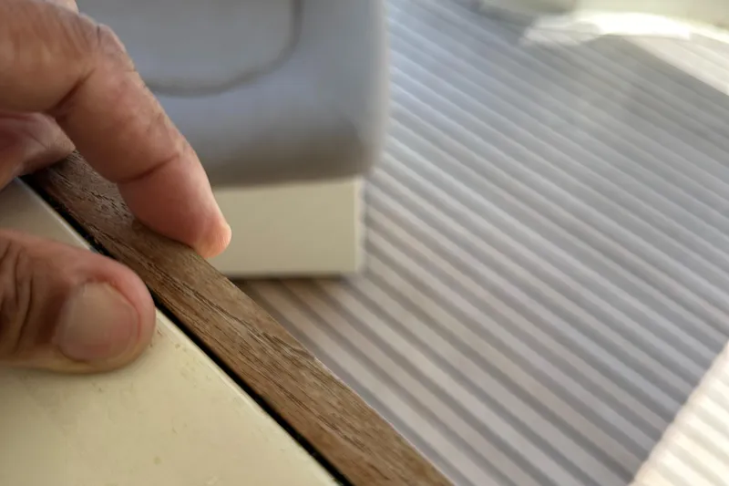  Yacht Photos Pics Close-up of hand touching wooden edge on 1998 Ferretti Yachts 80 interior.