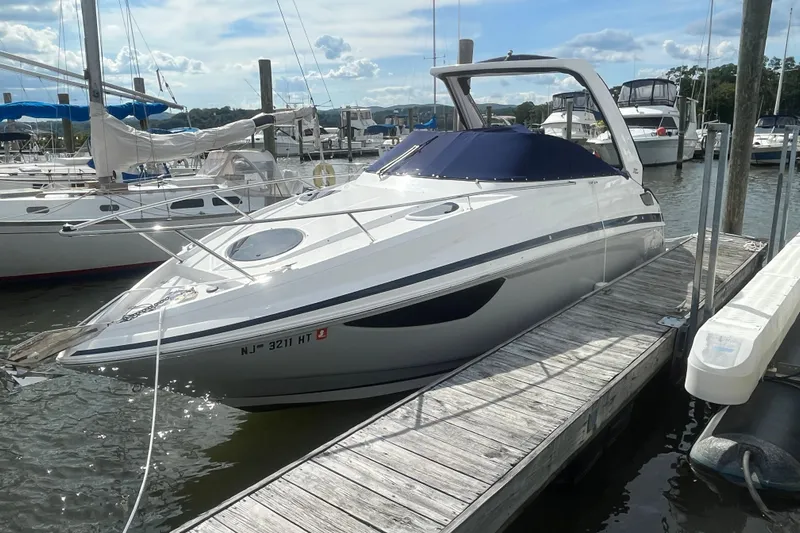  Yacht Photos Pics 2023 Regal 28 Express boat docked at marina under clear sky.