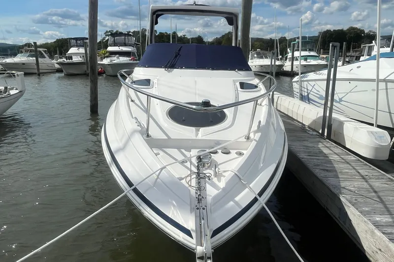  Yacht Photos Pics 2023 Regal 28 Express boat docked at marina under blue sky.