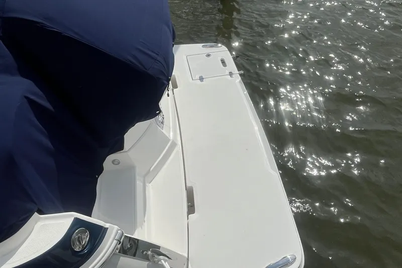  Yacht Photos Pics 2023 Regal 28 Express boat with sunlit water reflection.