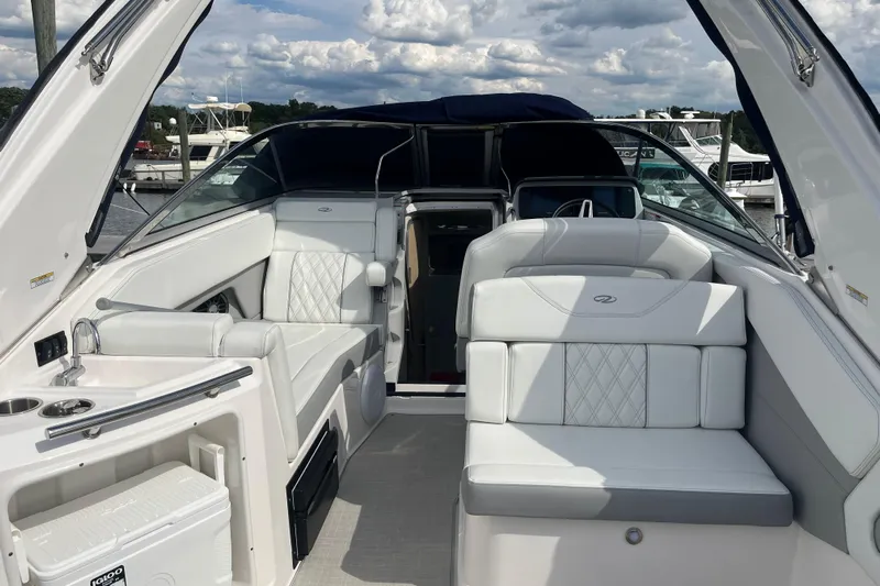  Yacht Photos Pics 2023 Regal 28 Express boat interior with white seating and modern amenities.