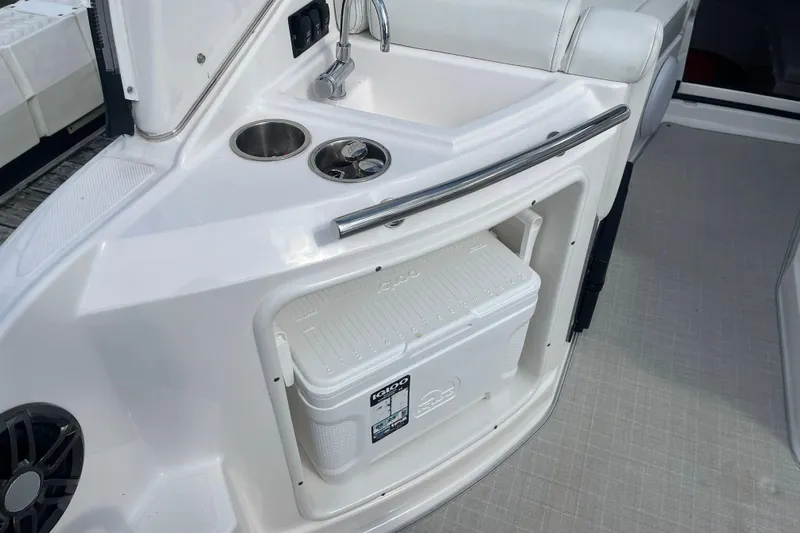  Yacht Photos Pics 2023 Regal 28 Express boat interior with sink, cup holders, and cooler storage.
