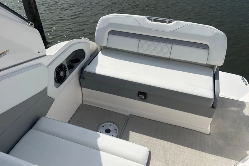  Yacht Photos Pics 2023 Regal 28 Express boat interior with cushioned seating and cup holders.
