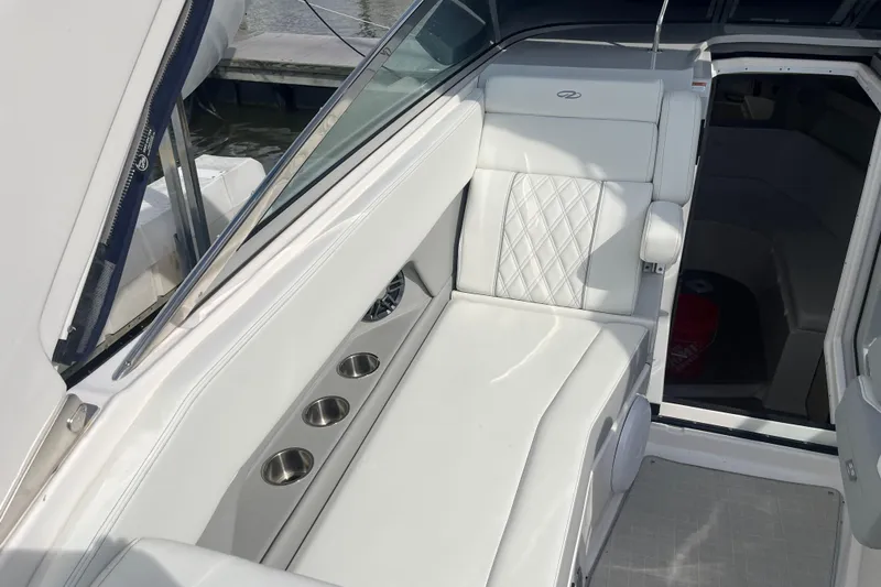  Yacht Photos Pics 2023 Regal 28 Express boat interior with white seating and cup holders.